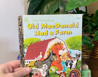 May include: A vintage "Old MacDonald Had a Farm" Little Golden Book. The cover features a farm scene with a red barn, a horse, a donkey, and various farm animals. The title is in yellow and blue.
