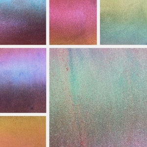 May include: Six different iridescent samples of glitter in various colours, including blue, green, pink, and gold.