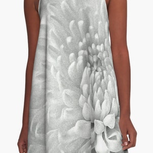 May include: A close-up of a white flower with a textured, layered center. The flower is in black and white.