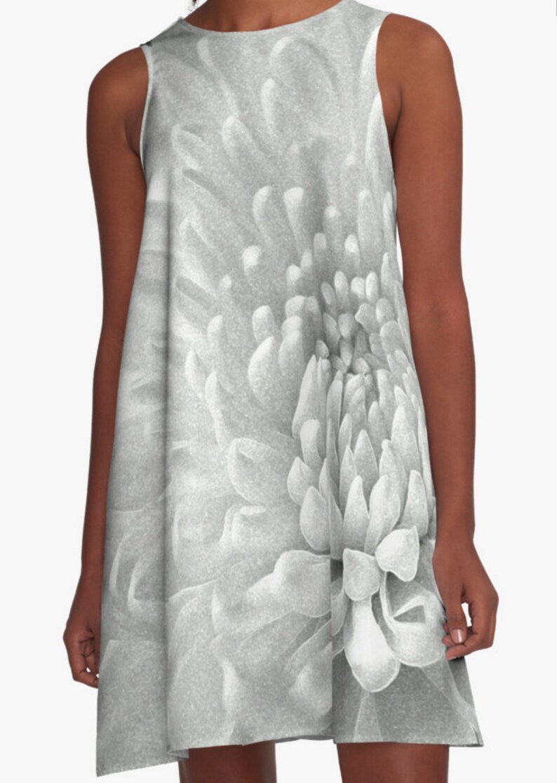 May include: A close-up of a white flower with a textured, layered center. The flower is in black and white.