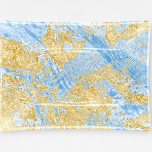 Puede incluir: Una bandeja rectangular de vidrio con un diseño de mármol azul y dorado. La bandeja tiene un borde ligeramente elevado.