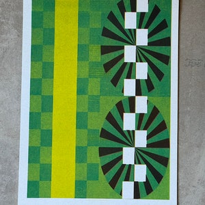May include: Abstract geometric design with a green and yellow checkered background. Two circles with black and white radiating lines are centered on the image.