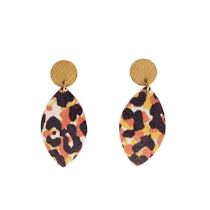 May include: A pair of earrings with a gold-coloured, textured circular stud and a teardrop-shaped pendant. The pendant has a cream background with black, orange, and yellow leopard print.