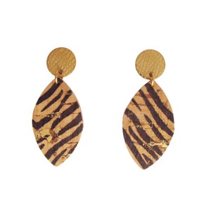 May include: A pair of drop earrings. Each earring has a gold-coloured, textured circular stud attached to a leaf-shaped pendant. The pendants have a cork base with dark brown zebra stripes and gold accents.