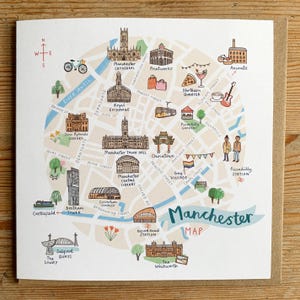 May include: An illustrated map of Manchester, UK, showing key landmarks such as the Cathedral, Town Hall, and Gay Village. The map is hand-drawn in a watercolour style, highlighting the city's main streets and attractions.
