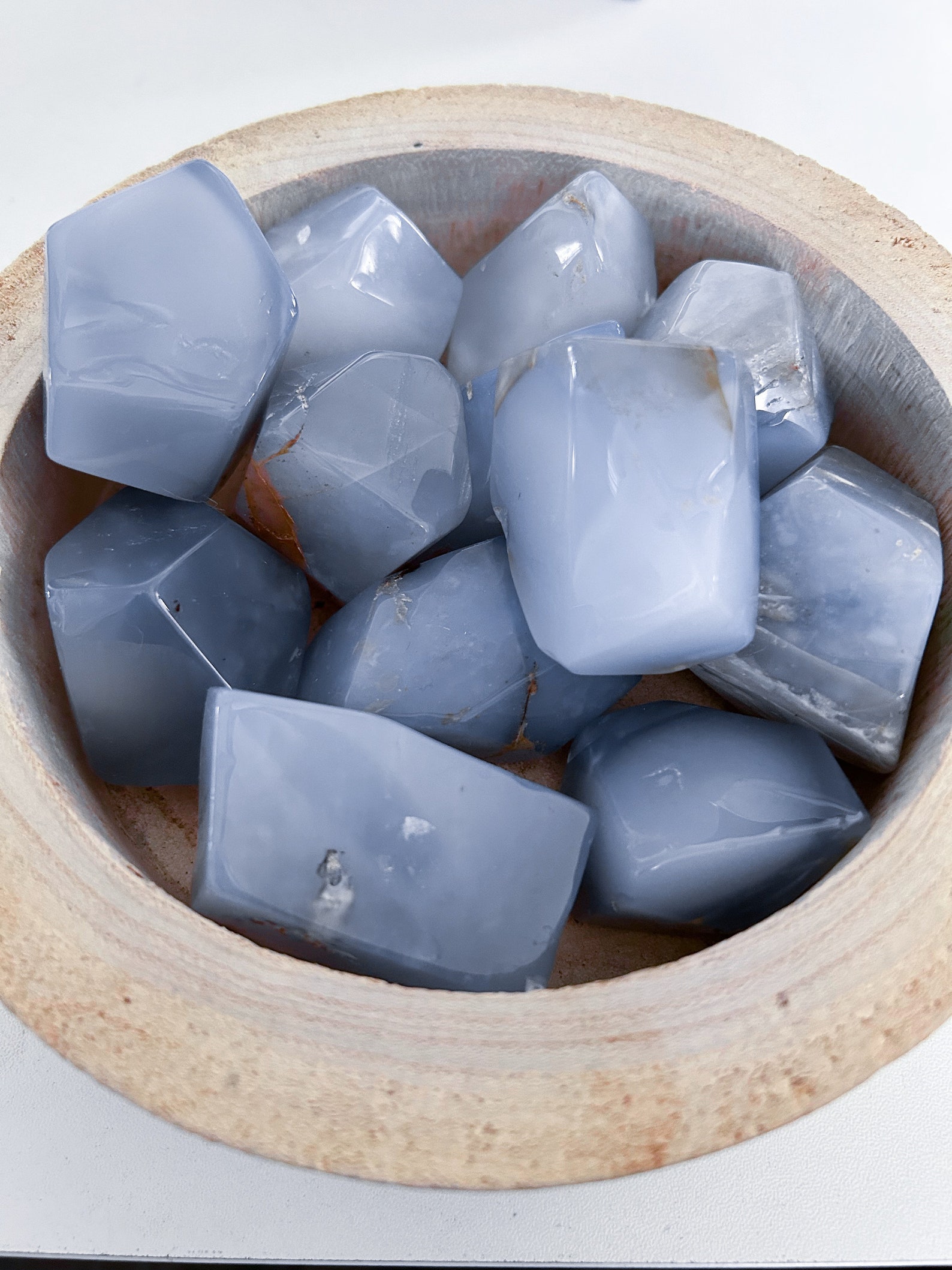 Bowl of polished blue chalcedony crystals for Cancer, ideal for emotional balance and gentle communication.
