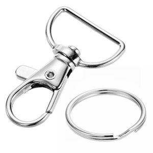 May include: Silver swivel lobster clasp with a silver key ring. The clasp has a spring-loaded gate and a D-ring.