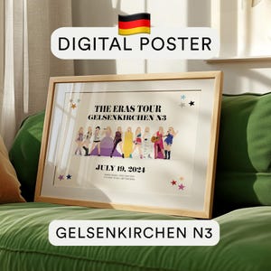May include: A framed digital poster with the text "DIGITAL POSTER" and "THE ERAS TOUR GELSENKIRCHEN N3 JULY 19, 2024". The poster features illustrations of people in colorful outfits. The frame is light brown.