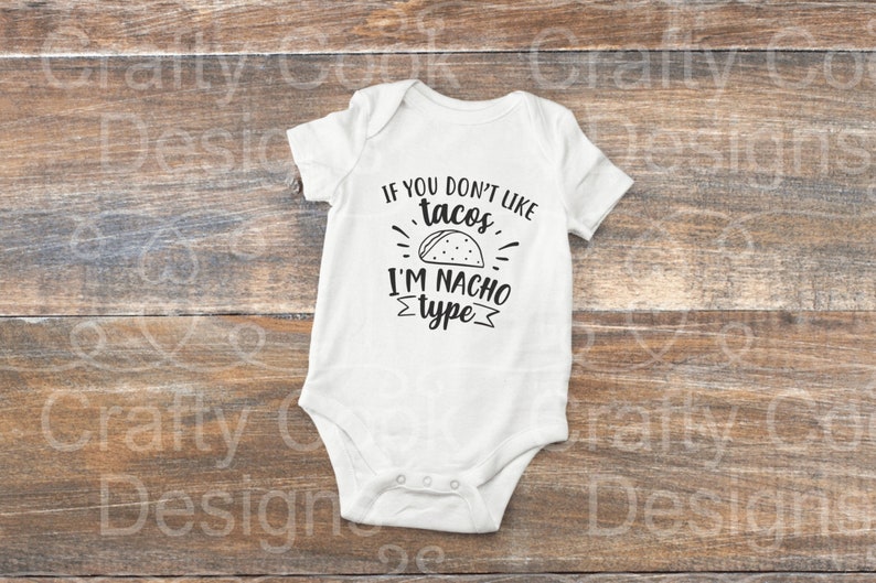 May include: White baby onesie with black text that reads "If you don't like tacos, I'm nacho type". The text is surrounded by a black outline and includes a black and white drawing of a taco.