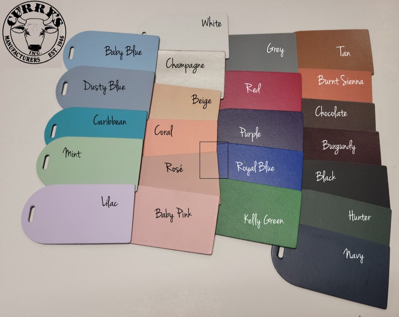 May include: A color chart with 20 different leather swatches. The swatches are arranged in two rows of ten. The colors include white, baby blue, dusty blue, caribbean, mint, lilac, champagne, beige, coral, rose, grey, tan, red, burnt sienna, purple, burgundy, royal blue, black, kelly green, hunter, and navy.