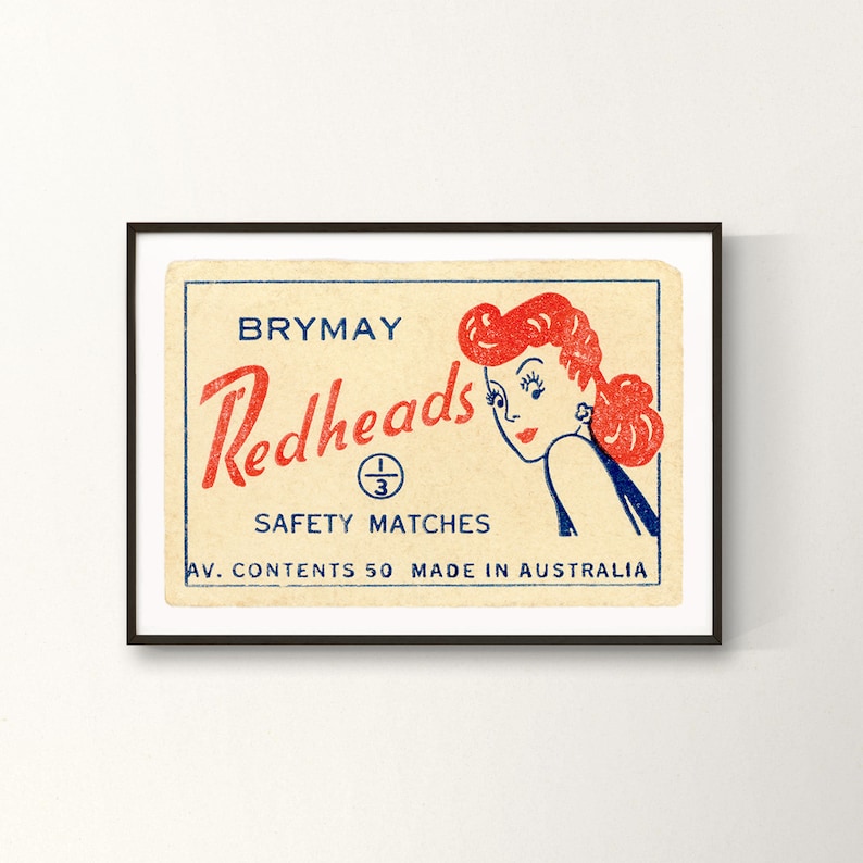 May include: Vintage matchbox label featuring a cartoon illustration of a woman with red hair, titled "Brymay Redheads" with the text "Safety Matches" and "Av. Contents 50 Made in Australia".