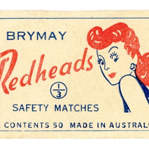 May include: A vintage matchbox with a red and blue design. The box features a cartoon illustration of a woman with red hair and the text "Brymay Redheads Safety Matches Av. Contents 50 Made in Australia".
