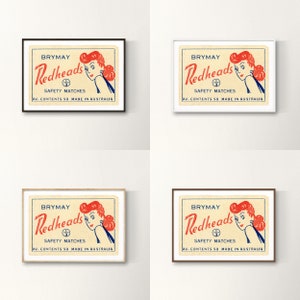 May include: A vintage matchbox label with a red and white illustration of a woman with red hair. The label reads "BRYMAY Redheads Safety Matches AV. CONTENTS 50 MADE IN AUSTRALIA".