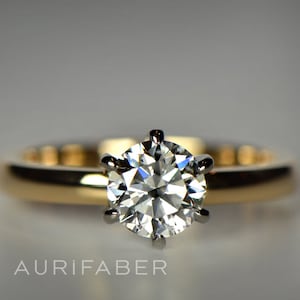 1.00ct diamond in yellow gold ring. GIA certificated one carat diamond ring. 1 carat diamond engagement ring. Diamond in white gold setting.