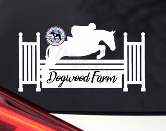 May include: White silhouette of a horse jumping over a fence with a rider on its back. The text "Dogwood Farm" is below the horse. A small circle with the text "The Divine Equine" is in the upper left corner.