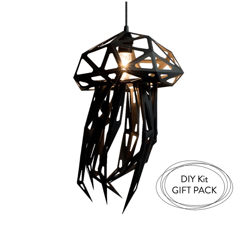 May include: Black metal DIY kit for a hanging light fixture shaped like a jellyfish. The kit includes all the parts needed to assemble the light fixture. The light fixture is lit with a light bulb. The text "DIY Kit GIFT PACK" is visible in the image.