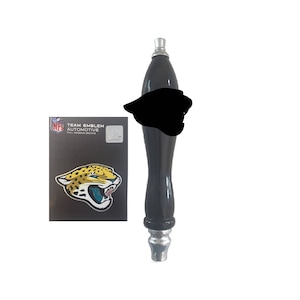 May include: Black and silver NFL Jacksonville Jaguars draft beer tap handle with a team logo sticker. The sticker features a yellow and black jaguar head with a blue mouth.
