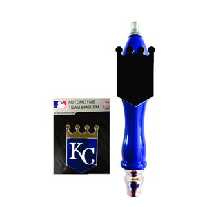 May include: A blue and silver beer tap handle with a black and gold Kansas City Royals logo. The logo features a crown and the letters "KC". The handle is labeled "Automotive Team Emblem".