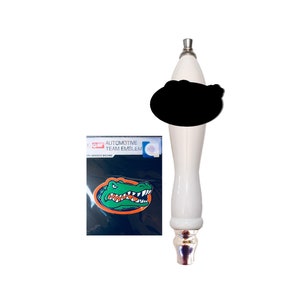May include: White beer tap handle with a black and white alligator decal. The decal says "Automotive Team Emblem".