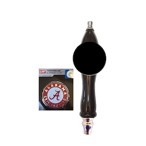 May include: A black and silver beer tap handle with a round emblem featuring the text "ALABAMA CRIMSON TIDE" around a white circle with a red "A". The handle has a glossy finish and a silver base.