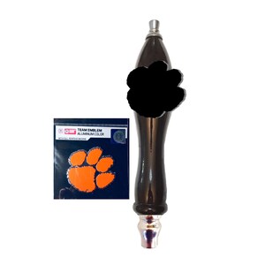 May include: Black and orange Clemson Tigers paw print team emblem aluminum color sticker with full adhesive backing. The sticker is attached to a black beer tap handle.