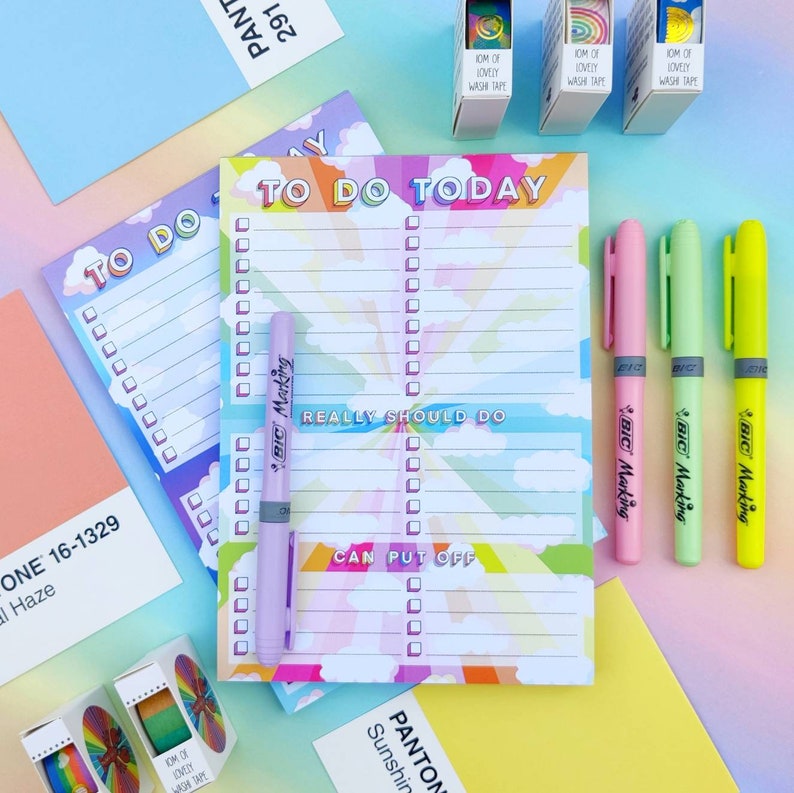 May include: Two rainbow-colored to-do list pads with the text "To Do Today" and "Really Should Do" and "Can Put Off". The pads are on a pink and blue background with colorful washi tape and highlighters.