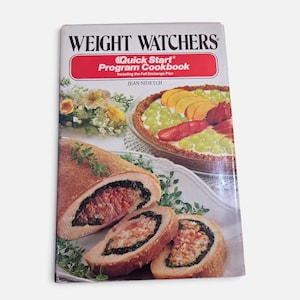May include: A Weight Watchers Quick Start Program Cookbook by Jean Nidetch. The cover features a fruit tart with grapes, peaches, and strawberries, alongside a sliced stuffed meat roll with green herbs on a white plate with floral accents.