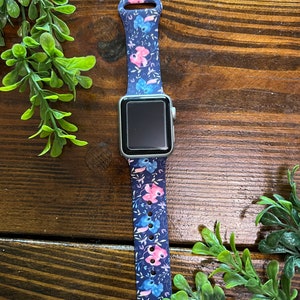May include: A blue and pink floral patterned silicone watch band for an Apple Watch.