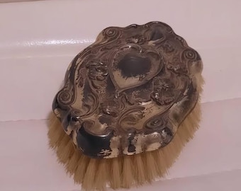 Cepillo quitapelusas antiguo de cerdas naturales, chapado en plata, de principios del siglo XX.