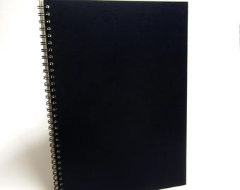 May include: A black spiral bound notebook with a textured cover.