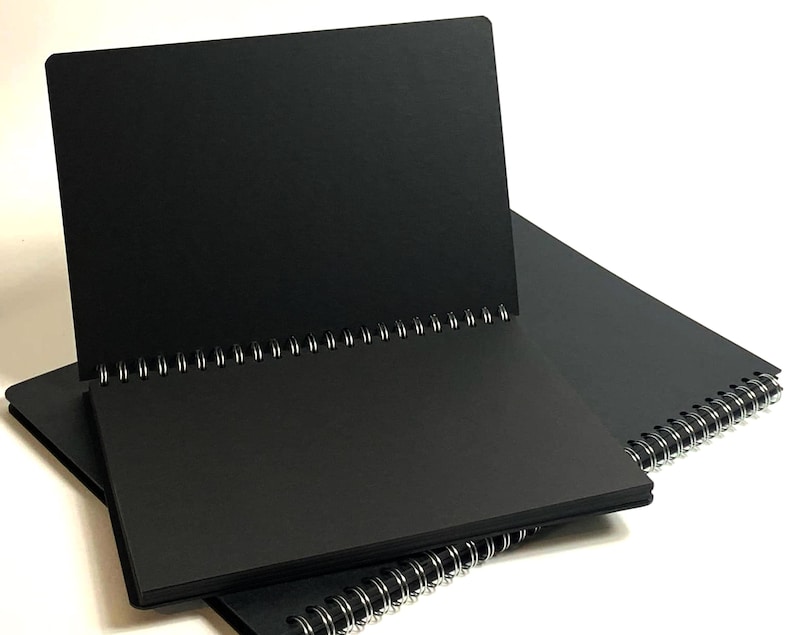 Hardback black card pages scrapbook photo album with 100 thick black card pages in portrait orientation.