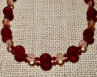 Cranberry red and pale pink beaded necklace.  Gorgeous, faceted cranberry and pink beads.  Single strand necklace.