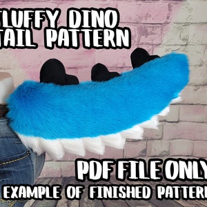 May include: A fluffy blue and white dinosaur tail with black accents. The tail is made of soft, plush material and features a row of white spikes along the bottom. Text on the image reads "FLUFFY DINO TAIL PATTERN" and "PDF FILE ONLY EXAMPLE OF FINISHED PATTERN."