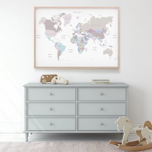 May include: A light blue dresser with six drawers and a wooden rocking horse in front of it. A framed world map with pastel colored countries hangs on the wall behind the dresser.