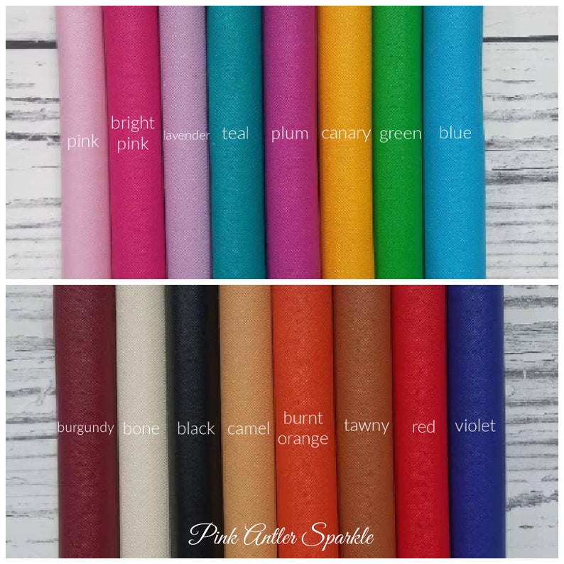 May include: A collection of 18 leather swatches in various colors, including pink, teal, plum, canary, green, blue, burgundy, bone, black, camel, burnt orange, tawny, red, and violet. The swatches are arranged in two rows, with the top row showing brighter colors and the bottom row showing darker colors. The text "Pink Antler Sparkle" is printed at the bottom of the image.