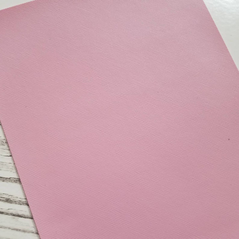 May include: A sheet of pale pink faux leather with a subtle textured pattern.