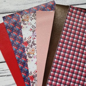 May include: Assortment of six fabric swatches in various patterns and colors. The swatches include a red plaid, a blue plaid, a floral print, a solid pink, a brown leather, and a red and black gingham.
