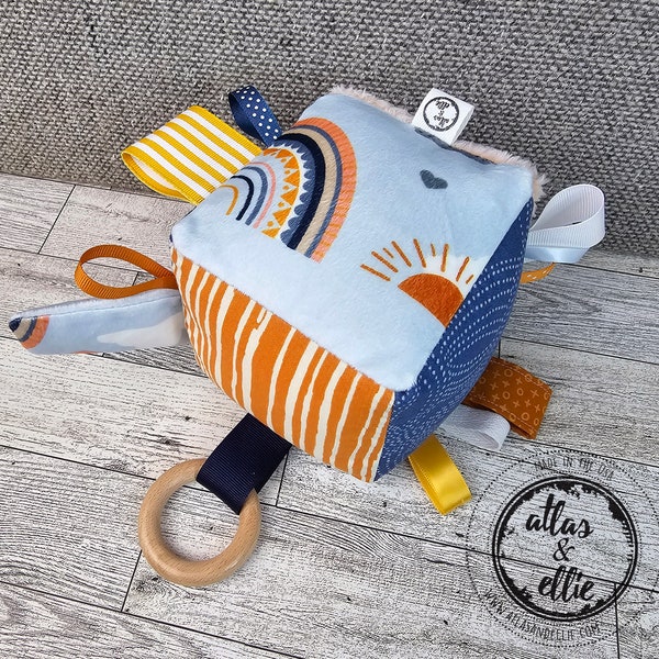 Sunny Sensory Activity Toy for Babies, Each side has textures and prints to enhance your baby's senses! A great toy for tummy time