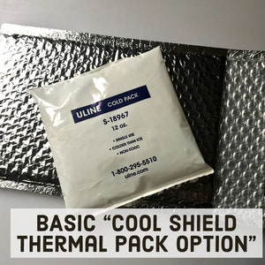 May include: A silver ULINE cold pack labeled "S-18967 12 oz." with the text "SINGLE USE, COLDER THAN ICE, NON-TOXIC" and the phone number 1-800-295-5510. The cold pack is sitting on a silver bubble wrap envelope. The text "BASIC "COOL SHIELD THERMAL PACK OPTION" is below the image.
