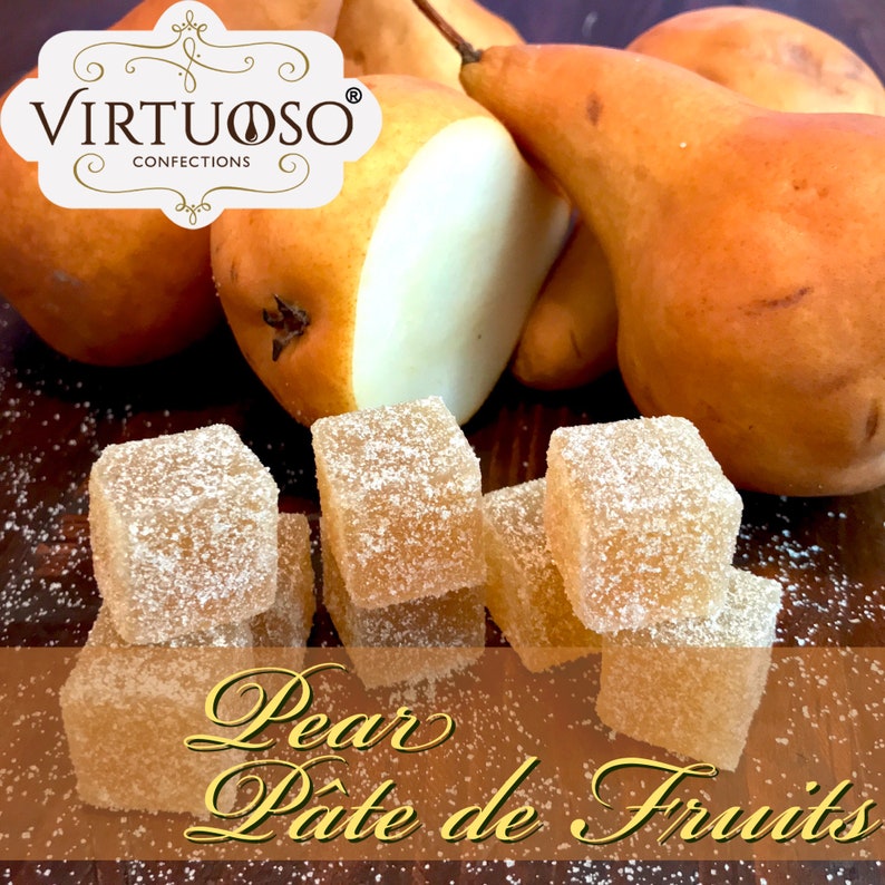 May include: A close-up of pear-flavored pate de fruits, a type of fruit jelly candy. The candies are square-shaped and dusted with powdered sugar. The image also features whole pears in the background.