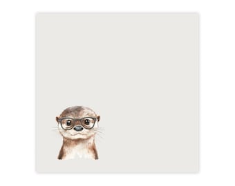 May include: A square, off-white decorative item featuring a watercolor illustration of an otter wearing round, black-rimmed glasses. The otter has brown fur and a white chest, set against a plain background.