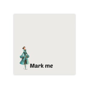 May include: A square, off-white sticker with an illustration of a person in a teal coat. The text "Mark me" is printed in black, sans-serif font. The sticker is likely for labeling or decoration.