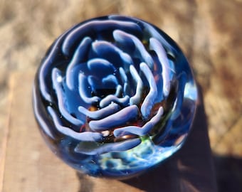 Pastel blue flower handmade borosilicate glass marble.Dr Sawfish 2026.