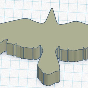 May include: A 3D-rendered, light-green raven figurine with outstretched wings. The raven's body is thick and solid, with a detailed wing design. The background is a grid pattern, suggesting a digital design or model.