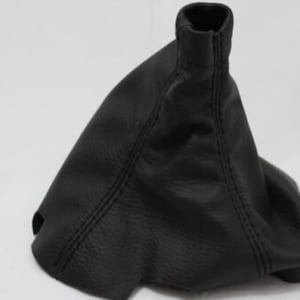 May include: Black leather gear shift boot with stitching.