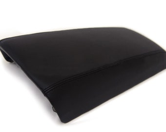 May include: Black leather center console armrest cover.
