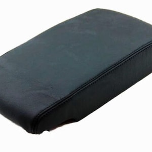 May include: Black leather center console armrest cover.