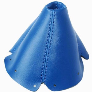May include: Blue leather gear shift boot cover. The cover has a cone shape with a stitched seam down the center.
