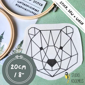 May include: A white fabric patch with a black geometric bear design. The patch is 8 inches in diameter and has the text "STICK, SEW + WASH" and "STUDIO KOOLMEES" printed on it.