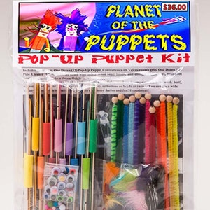 May include: A pop-up puppet kit called "Planet of the Puppets" includes 12 pop-up puppet controllers, pipe cleaners, googly eyes, feathers, and colorful pipe cleaners. The kit is packaged in a clear plastic bag with a colorful label.